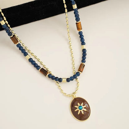 Caivera Gold Plated Brass Double Layer Necklace Set – Blue Beads and Brown Wood Pendant